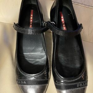 Prada black & silver Mary Jane flats w/Velcro strap. Worn once. Excellent cond.